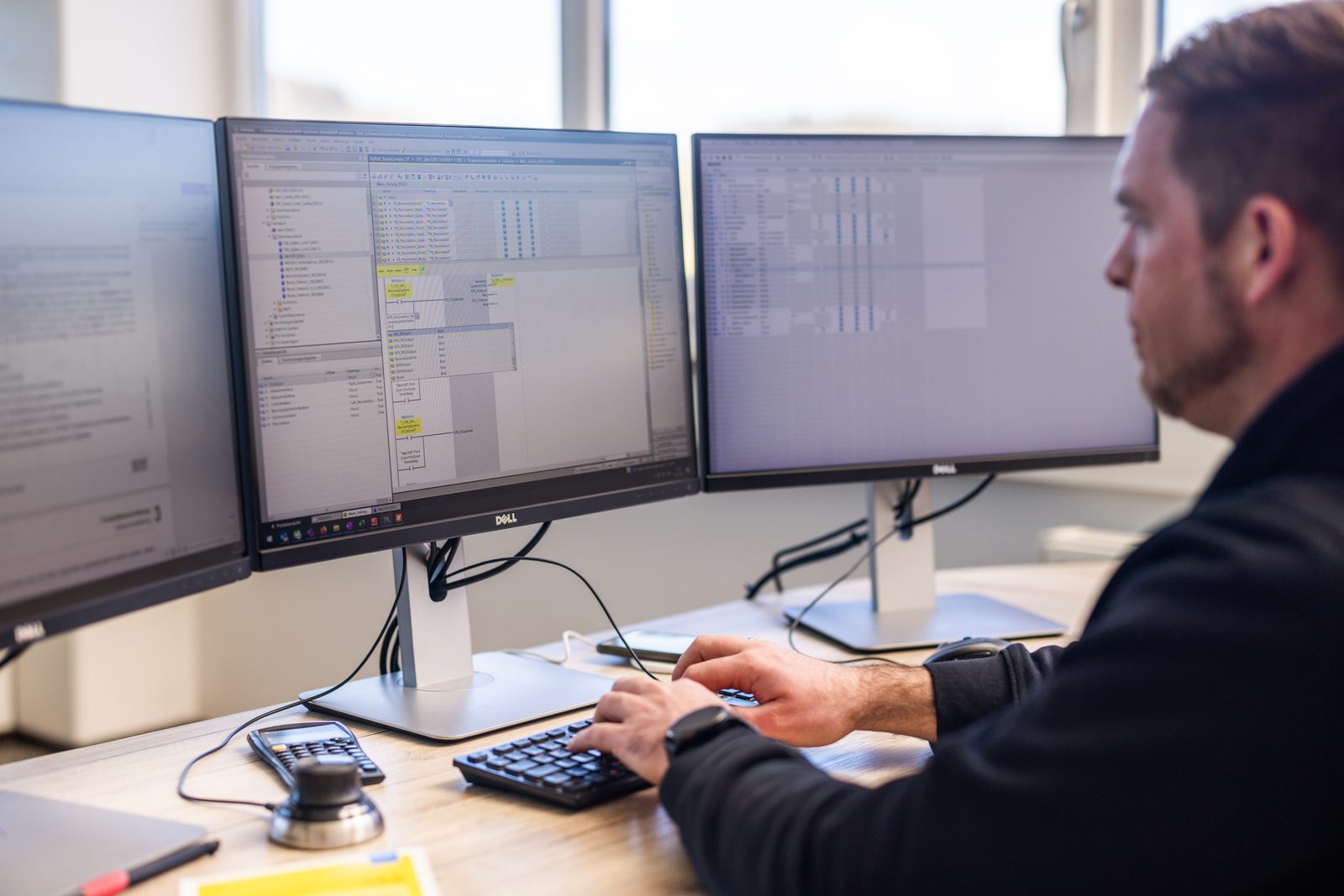 Two people working together on a control panel design at the computer