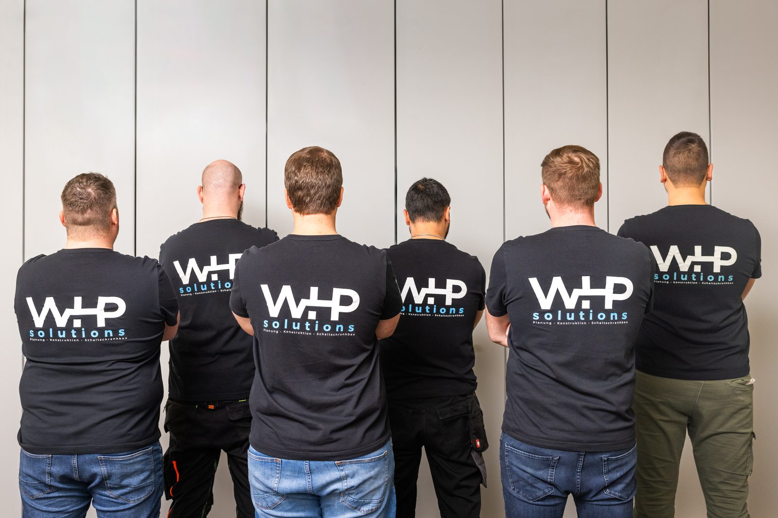 Team photo of WHP solutions with six people seen from behind