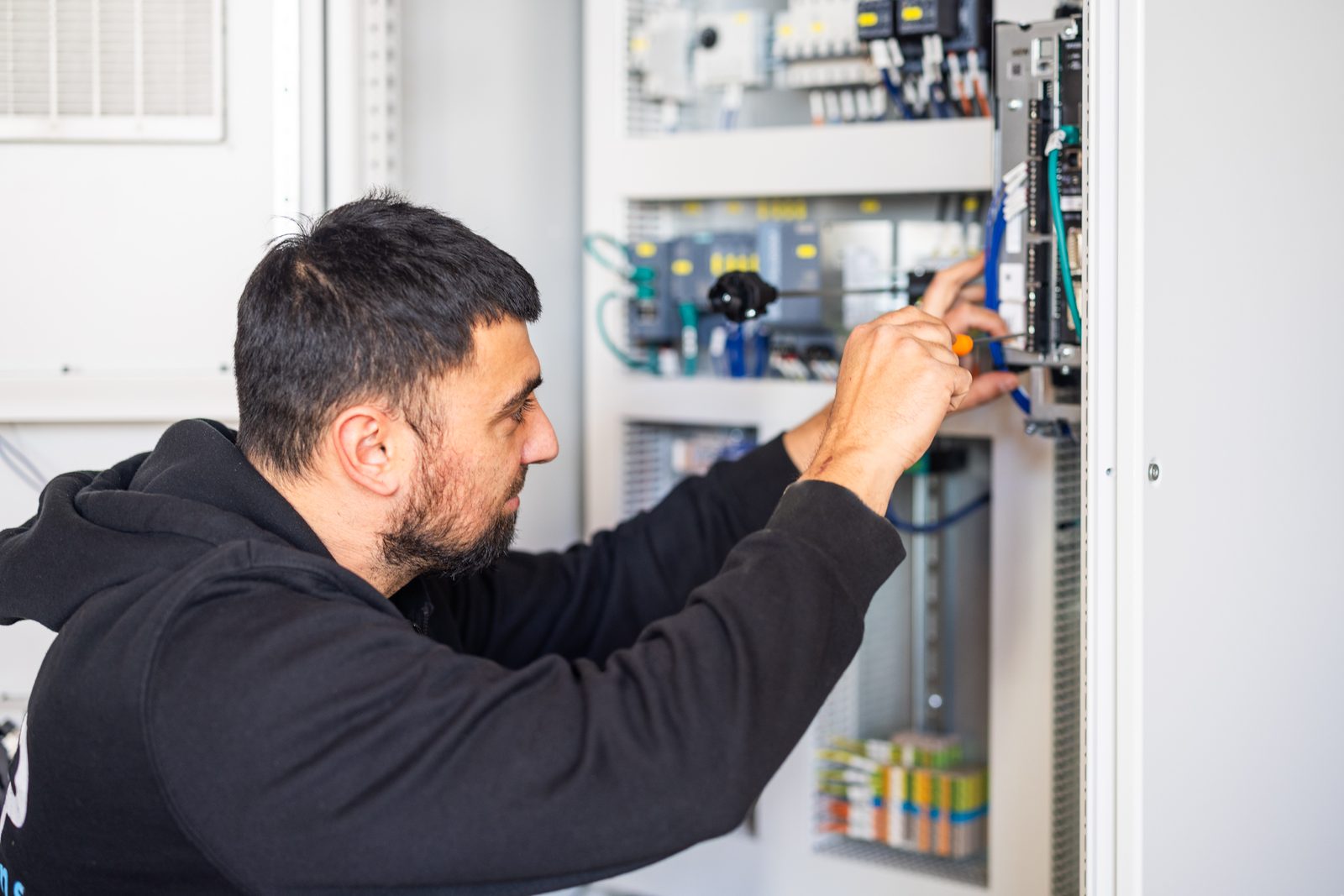A person wiring an electrical component